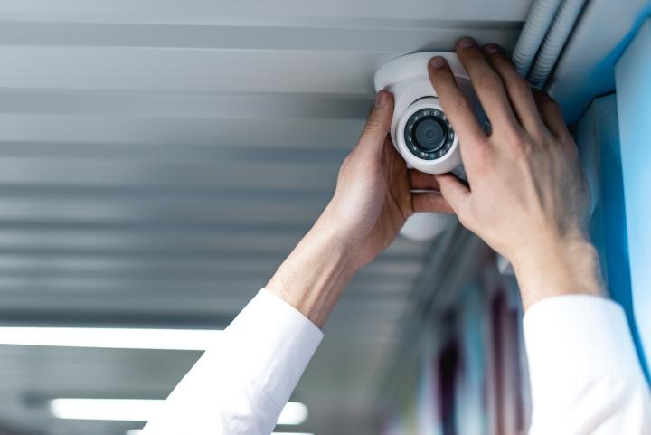 camera system partial view of man setting up security camera